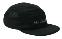 Other side panel of a black hat with part of the white Bodi Blends logo stitching showing on the front panel. The cap is made of 100% recycled polyester.
